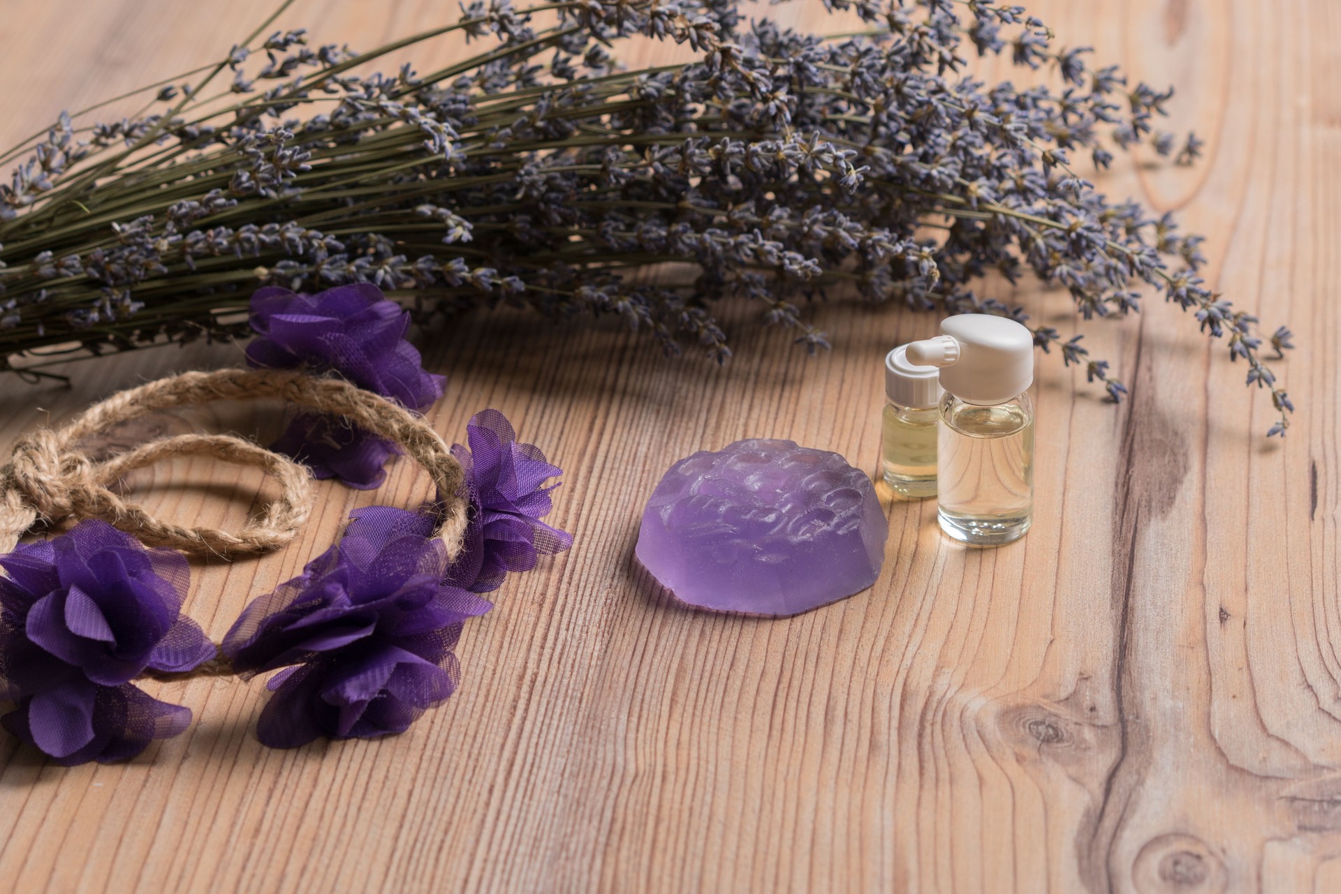 Herbal oil and lavender flowers on the wood table