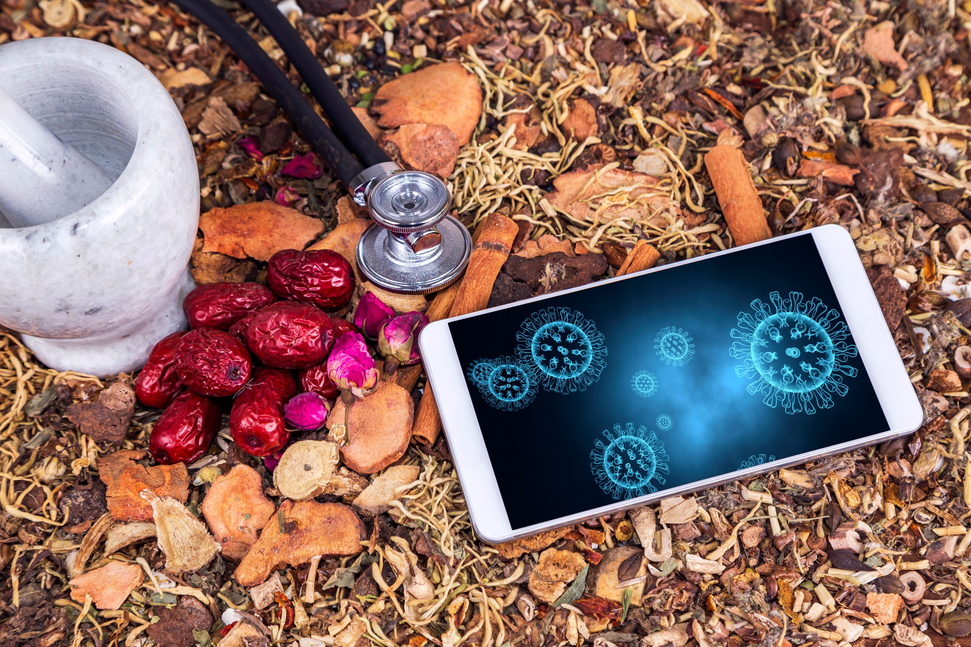 chinese medicine and mobile phone showing:prevention of covid-19